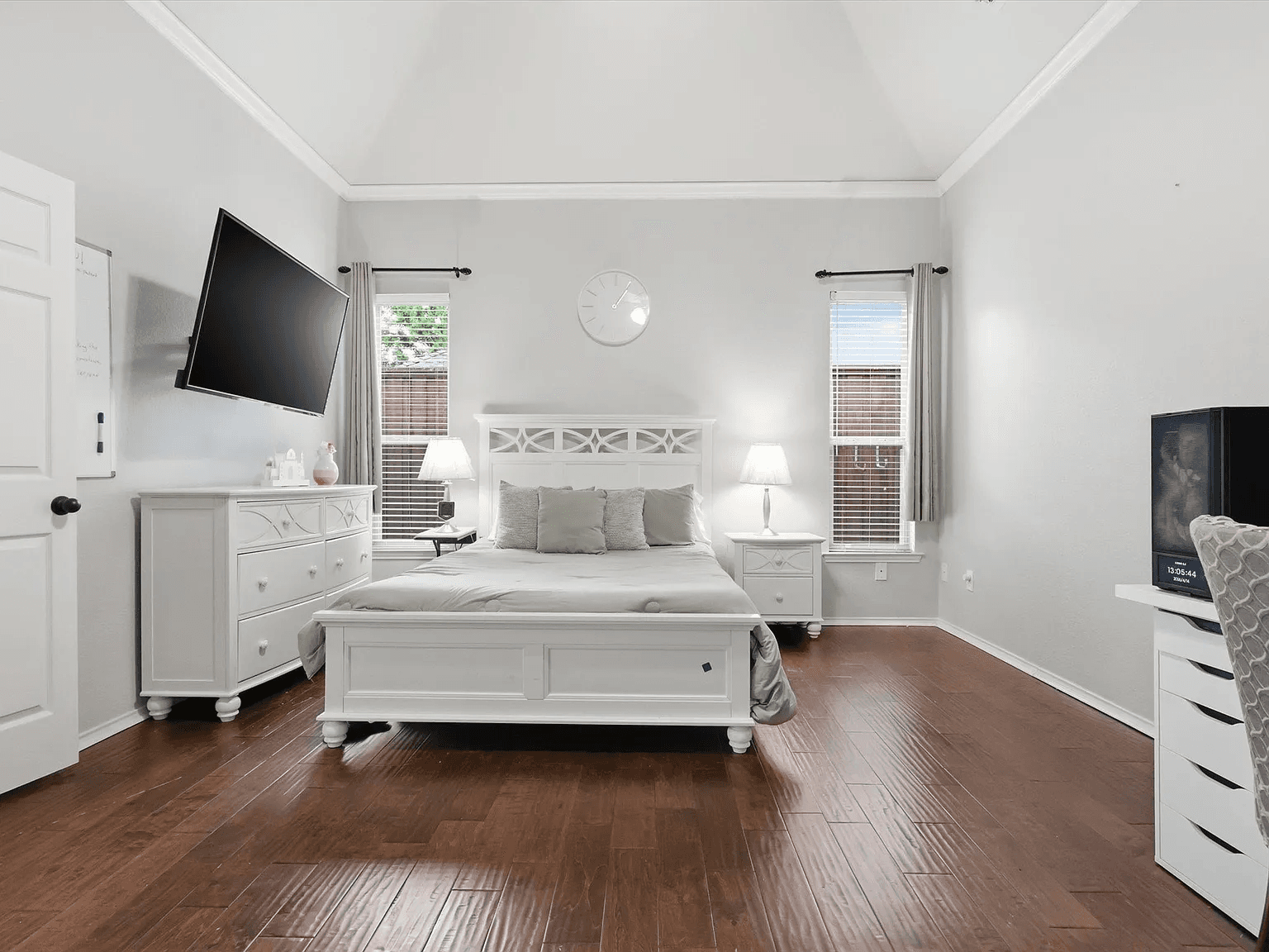 A fully furnished private bedroom with warm bedside lighting