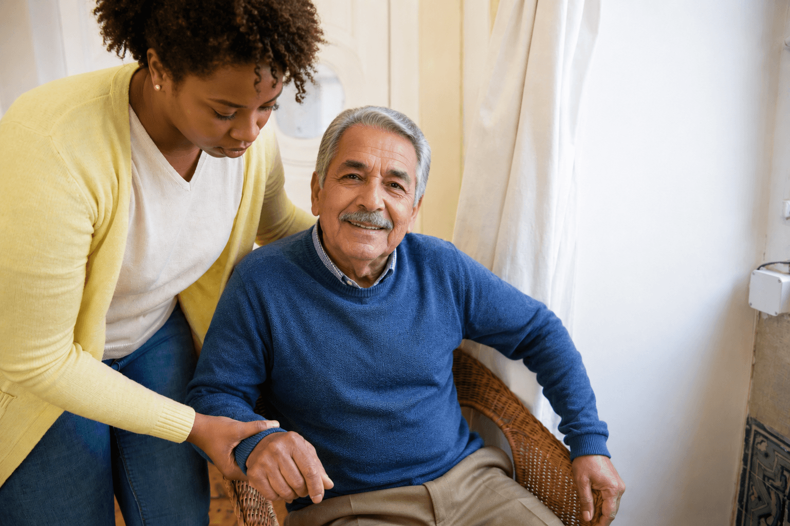 A caregiver sharing a laugh with a resident over coffee